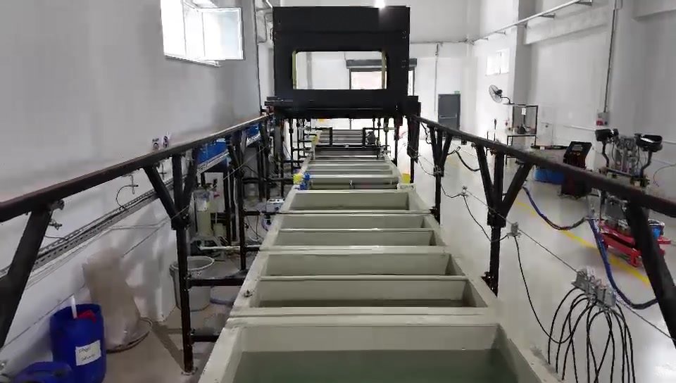 Row of electroplating tanks under a gantry