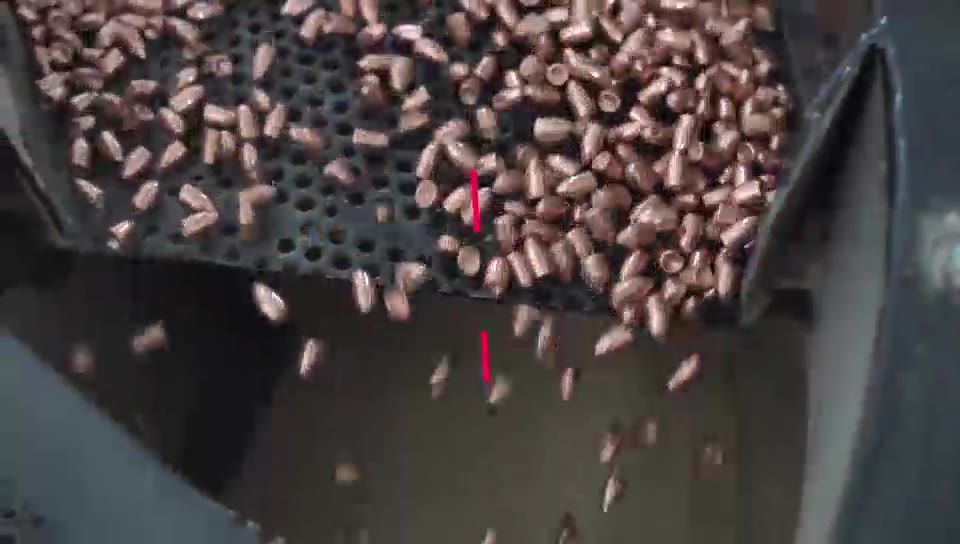 Copper-plated projectiles falling through a polishing screen